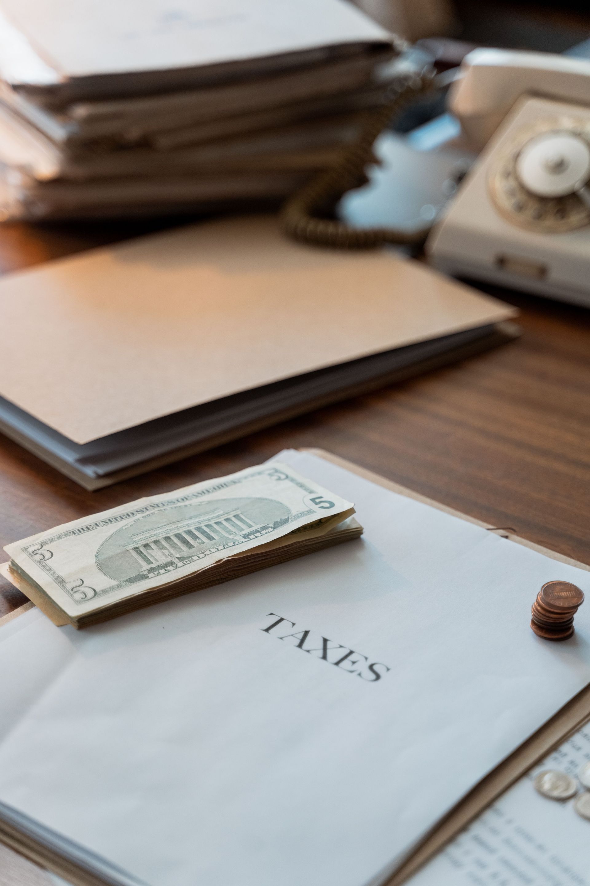 Retro-themed desk with tax papers and money, showcasing vintage office aesthetics.